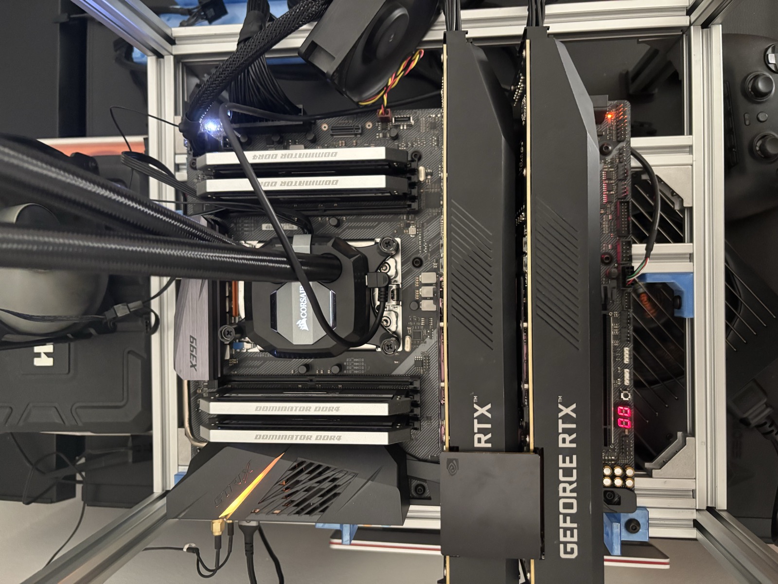 Two NVIDIA GeForce RTX 3090 GPUs mounted side by side in an open-frame build with Corsair Dominator DDR4 memory and AIO liquid cooling